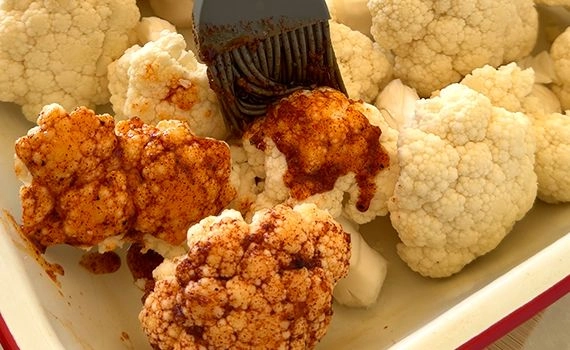 Paining cooking mixture onto cauliflower