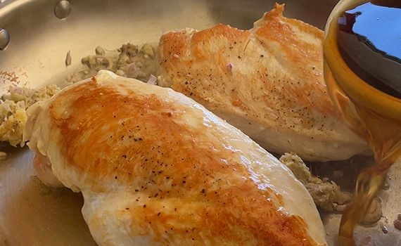 Flipping the chicken, adding the steaming liquid and aromats