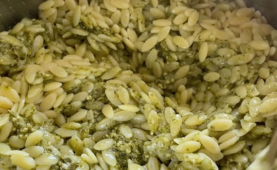 Pesto mixed in with cooked pasta