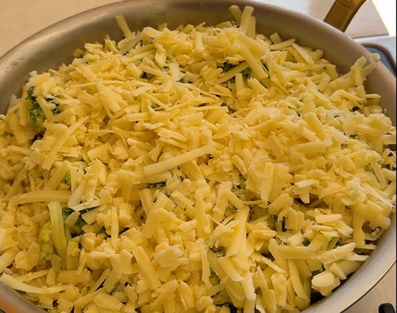 Grated cheese over a broccoli bake