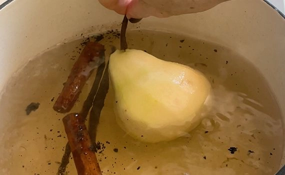 Adding pears to the poaching liquid
