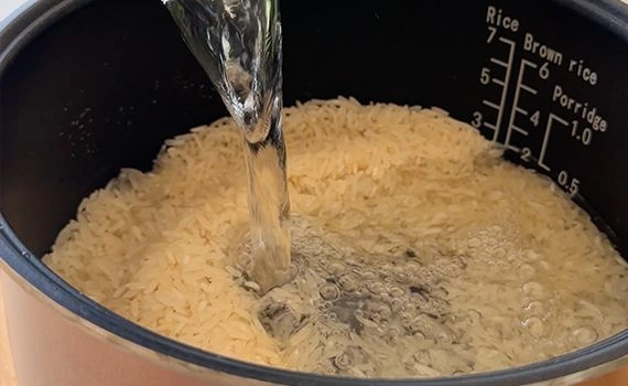 Adding water to rice