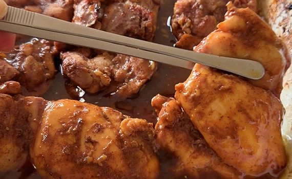 Turning chicken in a tray