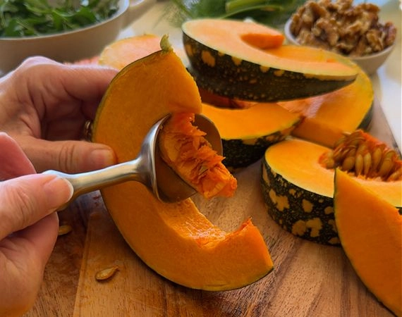 Removing seeds from a pumpkin wedge
