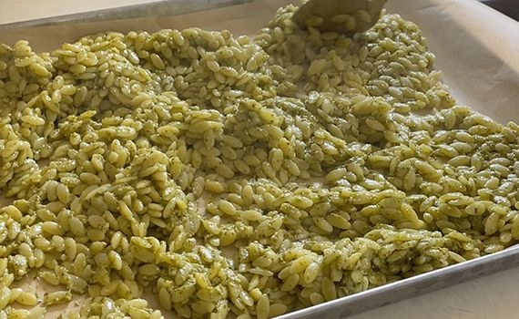 Pesto orzo cooling in a tray