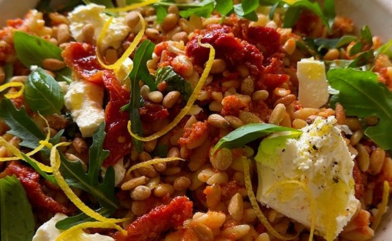 A close up of a sun-dried tomato pasta salad.