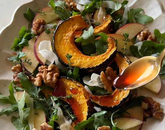Spooning agrodolce over a roast pumpkin apple and fennel salad.