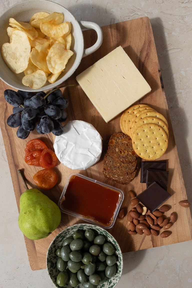 Ingredients to make a charcuterie board lunch plate.