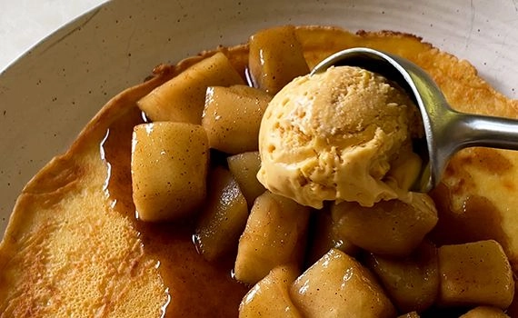 Adding apple pie filling and ice cream to a crepe