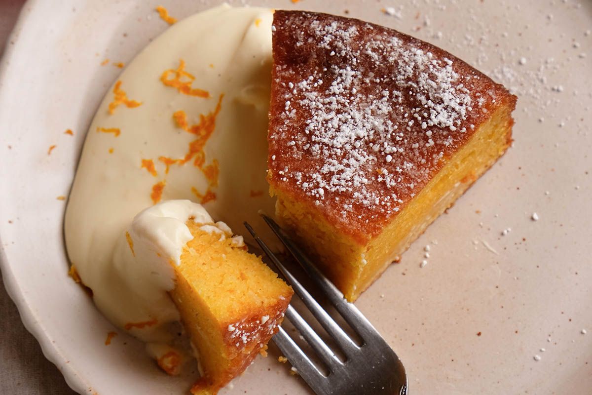A slice of clementine cake with cheesecake citrus cream.