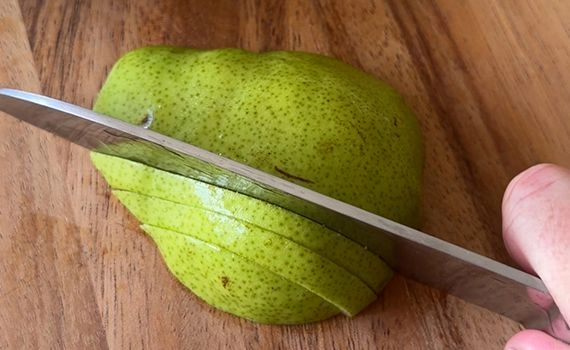 Pear being cut into slices