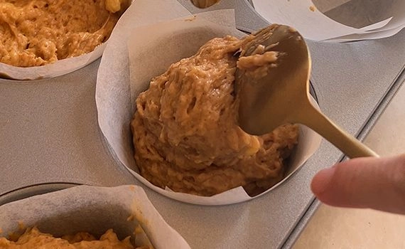 Adding batter to muffin tray