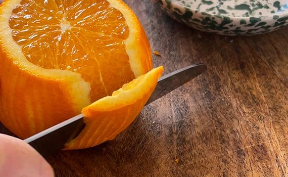 Slicing peel off an orange